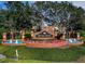 Seven Oaks community sign with brickwork, flowers and manicured greenery at 26920 Winged Elm Dr, Wesley Chapel, FL 33544