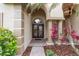 Elegant front entrance with double doors, brick walkway and beautiful landscaping at 26920 Winged Elm Dr, Wesley Chapel, FL 33544