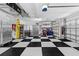 Well-organized garage with checkerboard flooring and lots of storage space at 26920 Winged Elm Dr, Wesley Chapel, FL 33544