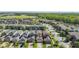 Wide aerial view showcasing the neighborhood's layout with homes, streets, and green spaces in a suburban landscape at 28642 Tranquil Lake Cir, Wesley Chapel, FL 33543