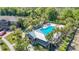 Aerial view featuring a community pool with palm trees and a view of a recreational neighborhood at 28642 Tranquil Lake Cir, Wesley Chapel, FL 33543