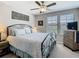 Comfortable bedroom with a wrought iron bed frame, large windows, and neutral decor at 28642 Tranquil Lake Cir, Wesley Chapel, FL 33543