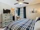 Comfortable bedroom featuring a cozy bed and dresser with a TV at 28642 Tranquil Lake Cir, Wesley Chapel, FL 33543