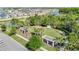 An aerial view showcases a community park with picnic pergolas and walking paths near a lakeside neighborhood at 28642 Tranquil Lake Cir, Wesley Chapel, FL 33543