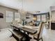 Elegant dining room with decorative chandelier and seating for six at 28642 Tranquil Lake Cir, Wesley Chapel, FL 33543