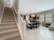 Spacious dining room open to kitchen features elegant chandelier and staircase to second floor at 28642 Tranquil Lake Cir, Wesley Chapel, FL 33543