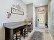 Inviting entryway with granite countertop desk area, decor, and convenient access to the home's interior at 28642 Tranquil Lake Cir, Wesley Chapel, FL 33543