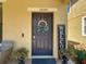 Close up of the front door with an elegant wreath and decorative accents at 28642 Tranquil Lake Cir, Wesley Chapel, FL 33543