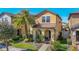 Attractive home with a covered porch, lush greenery, and a well-manicured lawn at 28642 Tranquil Lake Cir, Wesley Chapel, FL 33543