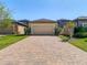 Well-maintained home featuring a two-car garage and a brick driveway at 28642 Tranquil Lake Cir, Wesley Chapel, FL 33543