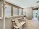Inviting upstairs hallway with bench seating, decorative accents, and natural light from nearby windows at 28642 Tranquil Lake Cir, Wesley Chapel, FL 33543