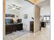 Open-concept view of home office with a view of the kitchen, featuring tile floors and warm colors at 28642 Tranquil Lake Cir, Wesley Chapel, FL 33543