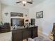 Well-lit home office featuring a large desk, dual monitors, and comfortable workspace at 28642 Tranquil Lake Cir, Wesley Chapel, FL 33543