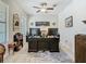 Spacious home office with large desk, dual monitors, ceiling fan, and natural light at 28642 Tranquil Lake Cir, Wesley Chapel, FL 33543