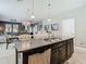 Kitchen with a central island, stainless steel appliances, and an open view to the dining and living areas at 28642 Tranquil Lake Cir, Wesley Chapel, FL 33543