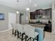 Modern kitchen boasts granite counters, an island, and dark wood cabinetry at 28642 Tranquil Lake Cir, Wesley Chapel, FL 33543