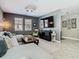 Comfortable living room featuring a sectional sofa and entertainment center at 28642 Tranquil Lake Cir, Wesley Chapel, FL 33543
