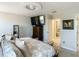 Spacious main bedroom with wall-mounted TV, dresser, and ensuite bathroom for convenience at 28642 Tranquil Lake Cir, Wesley Chapel, FL 33543