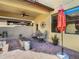 Stylish covered patio with comfortable seating and brick fire pit at 28642 Tranquil Lake Cir, Wesley Chapel, FL 33543