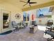 Inviting covered patio features comfortable seating and a modern ceiling fan at 28642 Tranquil Lake Cir, Wesley Chapel, FL 33543