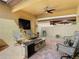 Cozy covered patio with a brick fire pit and a ceiling fan at 28642 Tranquil Lake Cir, Wesley Chapel, FL 33543