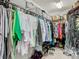 Well-organized walk-in closet with hanging clothes, shelving, and storage bins for optimal organization at 28642 Tranquil Lake Cir, Wesley Chapel, FL 33543