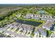 Aerial view of a community featuring modern townhomes, a pond and community amenities at 2895 Deer Pine Trl, Land O Lakes, FL 34638