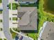 Aerial view of a well-maintained townhome with a meticulously landscaped yard and nearby pond at 2895 Deer Pine Trl, Land O Lakes, FL 34638