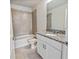 Bathroom featuring granite countertop, single sink, and tiled shower-tub combo at 2895 Deer Pine Trl, Land O Lakes, FL 34638