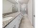Bathroom featuring double sinks, granite countertops, and a glass-enclosed shower at 2895 Deer Pine Trl, Land O Lakes, FL 34638