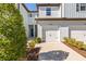 Charming townhome featuring an attached garage, landscaped front yard and freshly painted white exterior at 2895 Deer Pine Trl, Land O Lakes, FL 34638