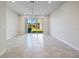 Spacious and bright living area with tiled floors, a ceiling fan, and sliding glass doors to the patio at 2895 Deer Pine Trl, Land O Lakes, FL 34638
