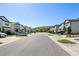 Serene street view of a well-maintained neighborhood featuring modern townhomes and lush landscaping at 2895 Deer Pine Trl, Land O Lakes, FL 34638