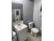 Cozy half bathroom with toilet, vanity, decorations, and updated fixtures at 2910 Lichen Ln # B, Clearwater, FL 33760