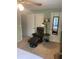 View of a bedroom showing a comfortable leather chair and a door with a mirror at 2910 Lichen Ln # B, Clearwater, FL 33760