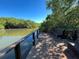 View of community dock with bench overlooking waterway lined with mangroves at 2910 Lichen Ln # B, Clearwater, FL 33760
