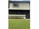 View of front exterior with screened in porch and green lawn at 2910 Lichen Ln # B, Clearwater, FL 33760