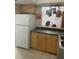 Kitchen view of ample storage in wooden cabinets, stainless steel sink and view into adjacent workspace at 2910 Lichen Ln # B, Clearwater, FL 33760