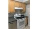 Kitchen area with stainless dishwasher, smooth top stove, and neutral cabinetry at 2910 Lichen Ln # B, Clearwater, FL 33760