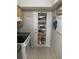 Pantry organization with door rack and kitchen appliances at 2910 Lichen Ln # B, Clearwater, FL 33760