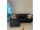 Living room featuring black leather sectional sofa and unique throw pillows at 2910 Lichen Ln # B, Clearwater, FL 33760