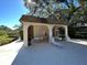 Poolside lounge area with shade, tables, and lounge chairs for relaxation at 2910 Lichen Ln # B, Clearwater, FL 33760