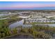 Aerial view of a Primary planned community with lakes, landscaping, and residential homes at 33736 Ocean Spray Ln, Wesley Chapel, FL 33543