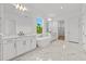 Elegant bathroom featuring dual sinks, a soaking tub, and designer fixtures at 33736 Ocean Spray Ln, Wesley Chapel, FL 33543