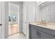 Stylish bathroom featuring modern gray vanity with gold fixtures and bright lighting at 33736 Ocean Spray Ln, Wesley Chapel, FL 33543