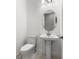 Powder room featuring a pedestal sink and modern fixtures at 33736 Ocean Spray Ln, Wesley Chapel, FL 33543