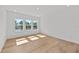 Bright bedroom showcasing three large windows offering serene pond views and natural light at 33736 Ocean Spray Ln, Wesley Chapel, FL 33543