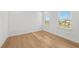 A light filled room with hardwood floors and large windows at 33736 Ocean Spray Ln, Wesley Chapel, FL 33543