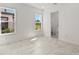 Bedroom with an ensuite bathroom and view through the windows to the exterior at 33736 Ocean Spray Ln, Wesley Chapel, FL 33543