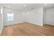 Bright bedroom boasts hardwood floors, recessed lighting, and a large window at 33736 Ocean Spray Ln, Wesley Chapel, FL 33543
